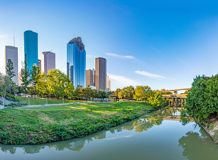 A river is shown on the lower half of the photo, with skyscrapers and bridges in the background. 
