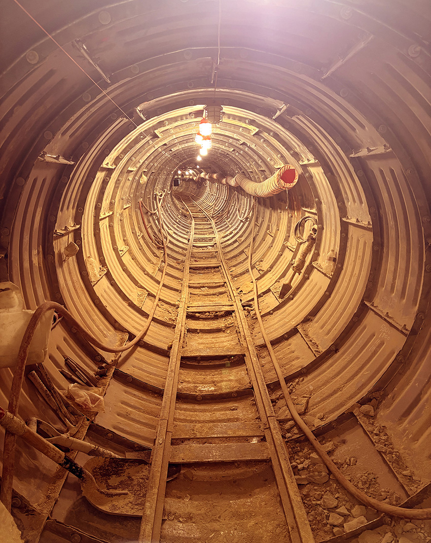 Photo shows the interior of a tunnel for a portion of an underground sewer project. 