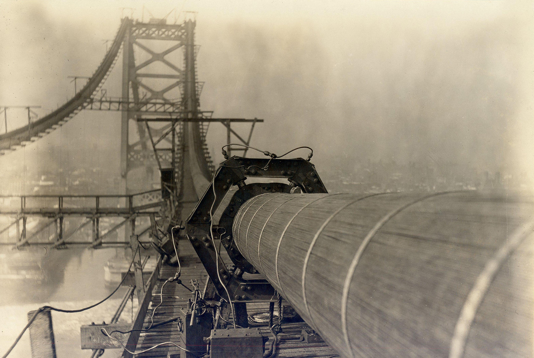 Picture shows a large cable made up of many wires getting squeezed by a six-sided machine into a smaller diameter.
