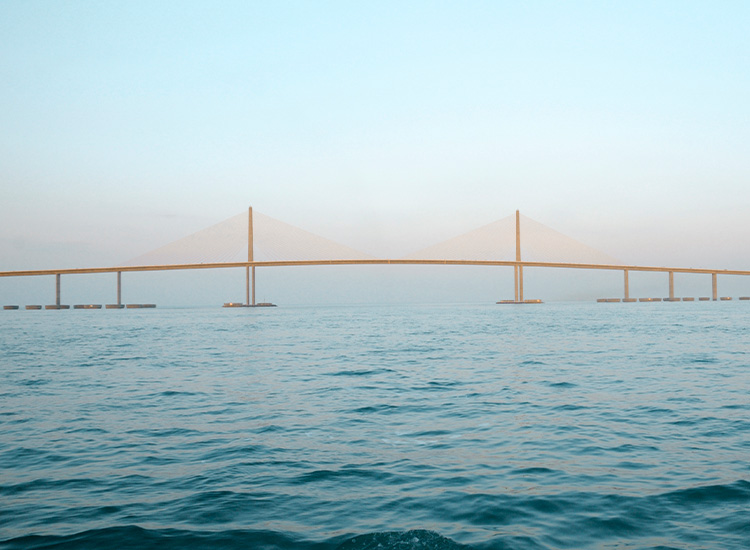 A panoramic view shows the cable-stayed Sunshine Skyway Bridge stretching across the waters of Tampa Bay.