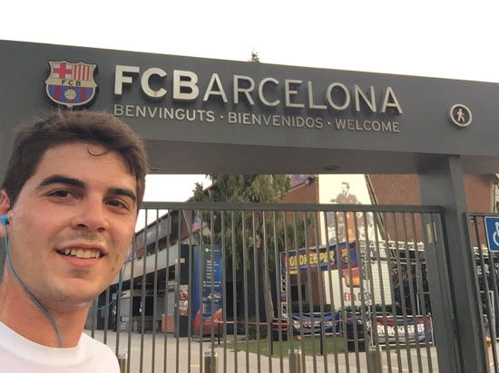 Photo of man in front of soccer stadium