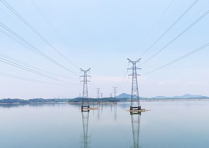 High tension wires and towers over water 
