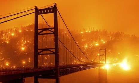 photo of bridge in front of wildfire