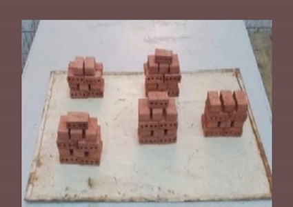Brick prototypes stacked on a tray after firing