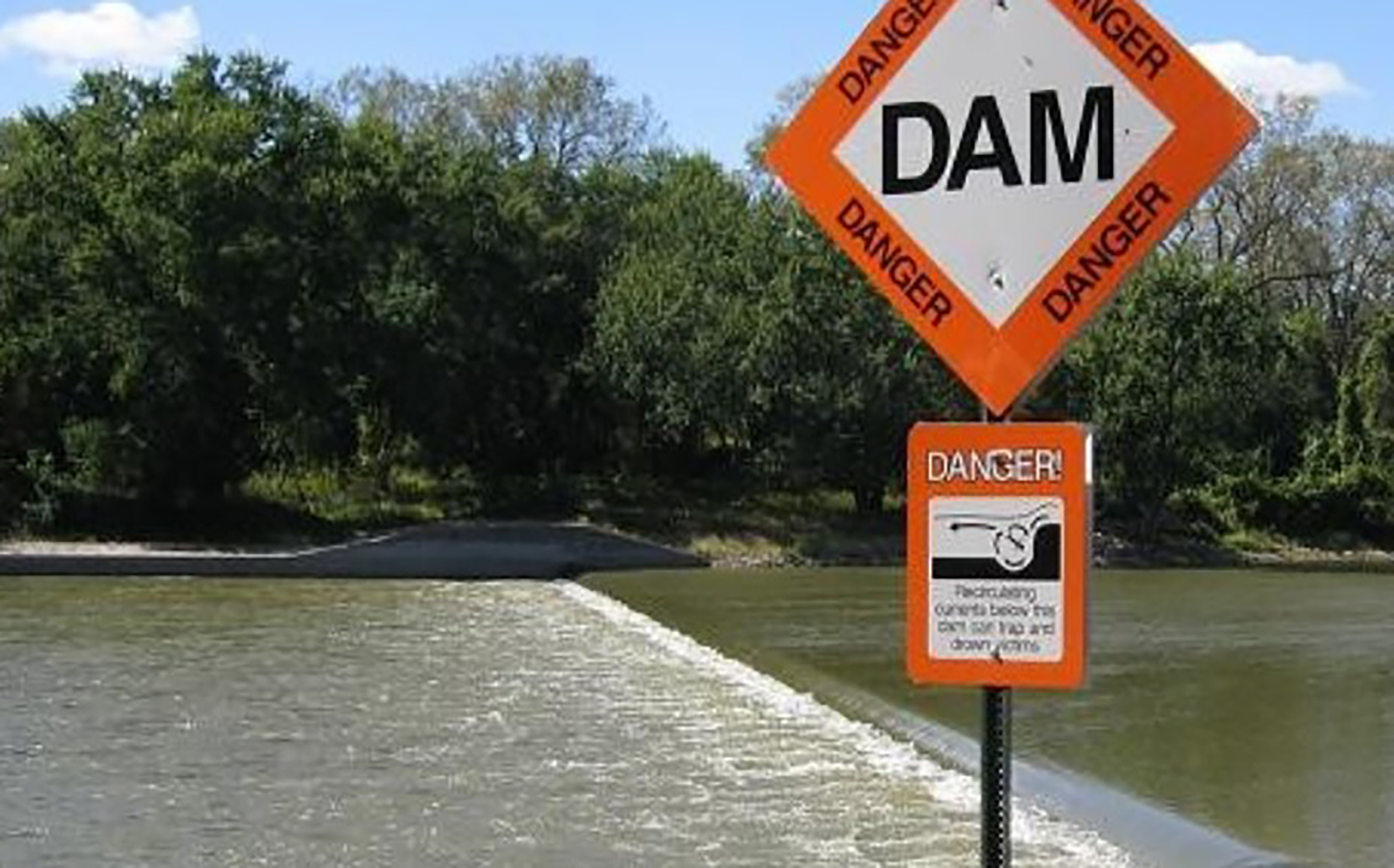 a dam with warning signs a dam with warning signs
