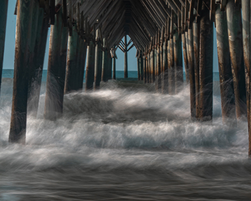 Waves crashing into piers 