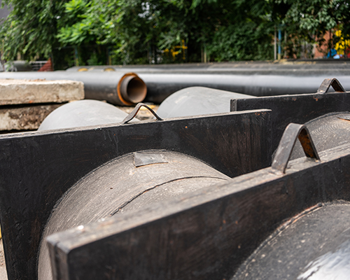Closeup of two new insulated water pipes on city road