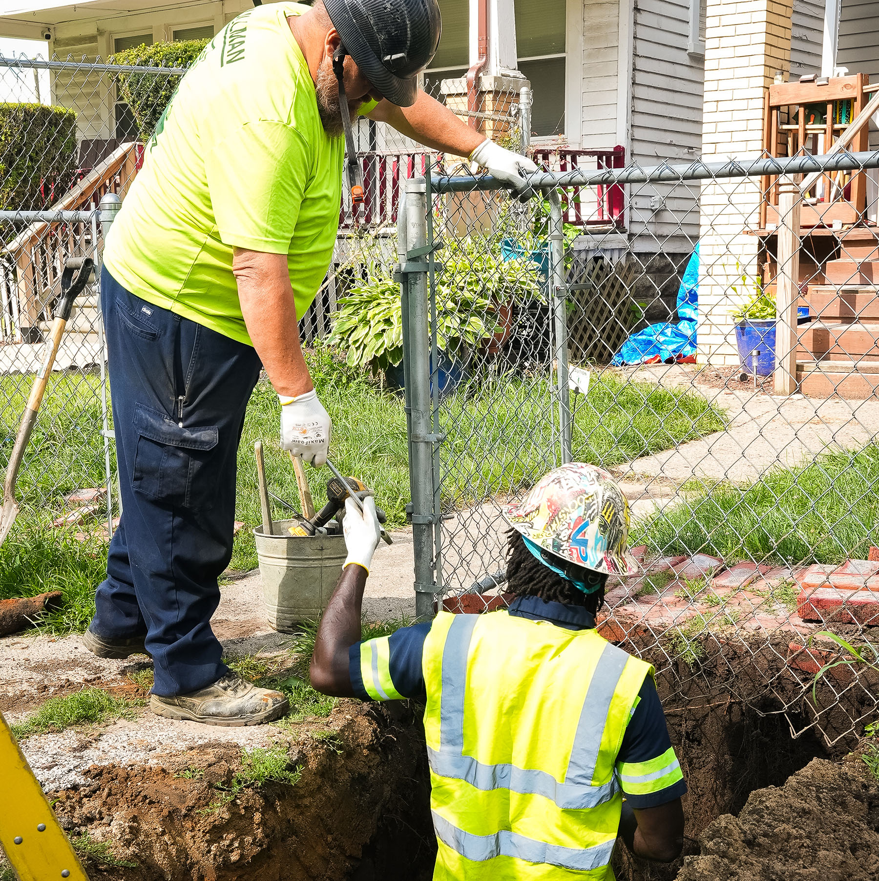 two men work to replace a service line