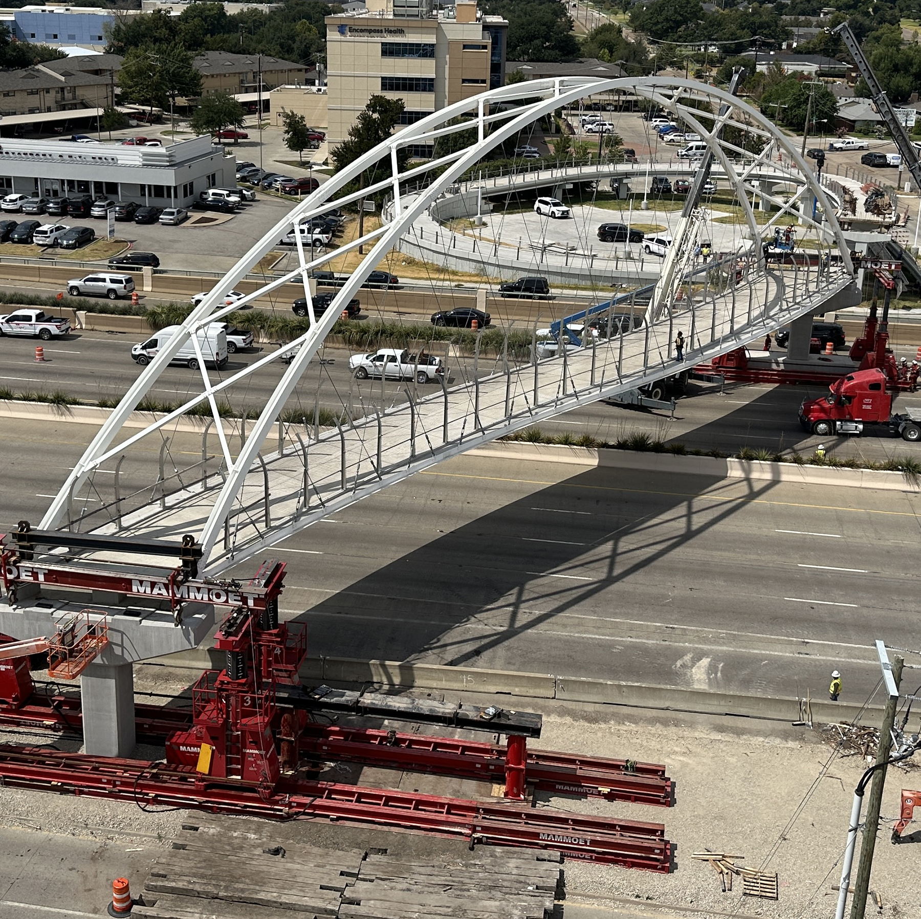 a pedestrian bridge spans a highway