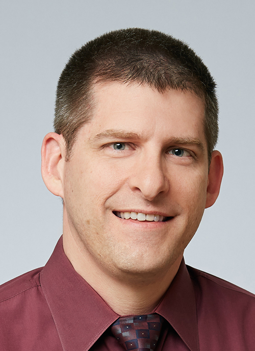 man smiles for the camera