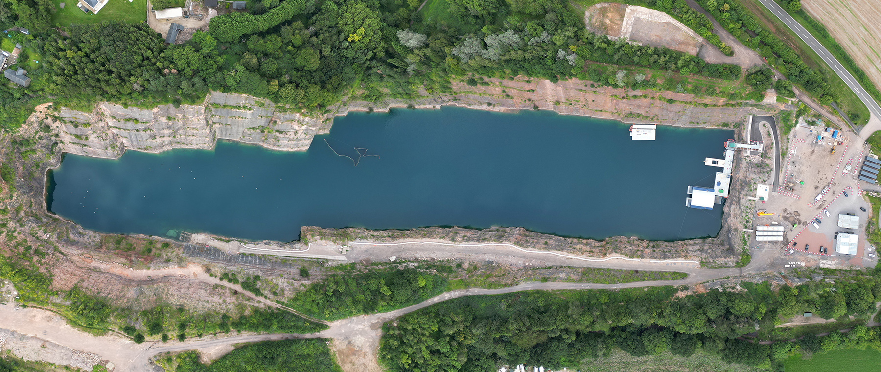 aerial view of large water body surrounded by trees and buildings
