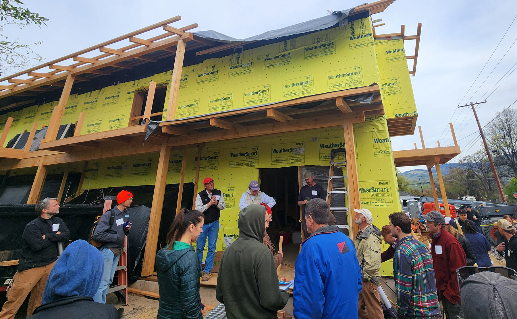 people surround a structure under construction people surround a structure under construction