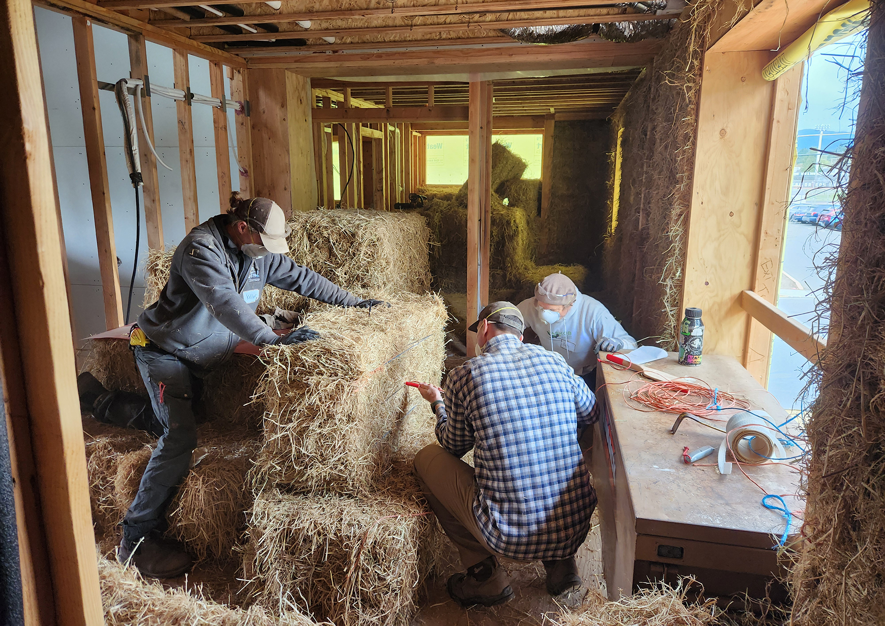 people work with straw bale construction people work with straw bale construction