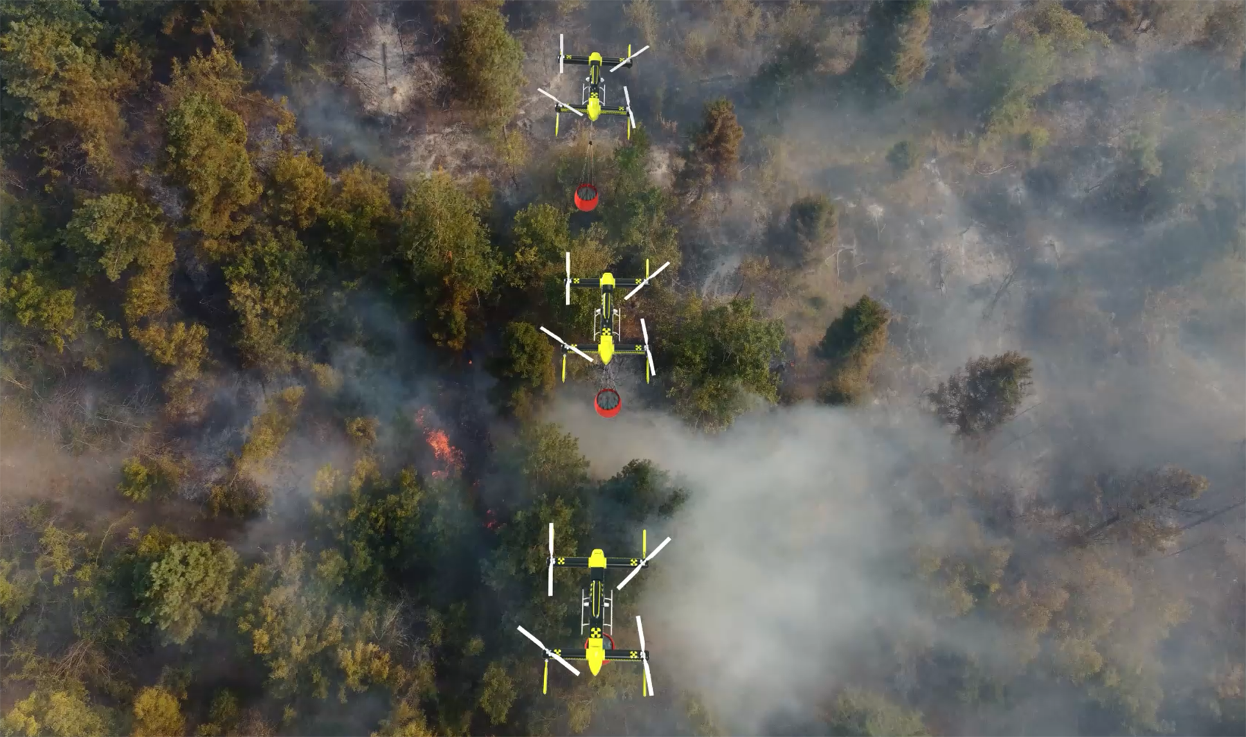 drones fly over an area heavy with trees with smoke billowing drones fly over an area heavy with trees with smoke billowing