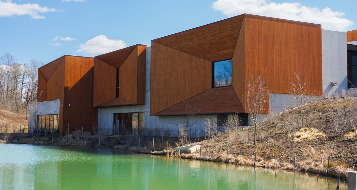 a timber-heavy building sits along the water a timber-heavy building sits along the water