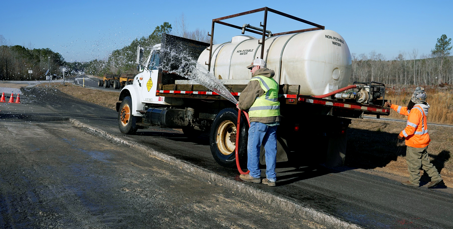 crew and a trucck works with the asphalt crew and a trucck works with the asphalt