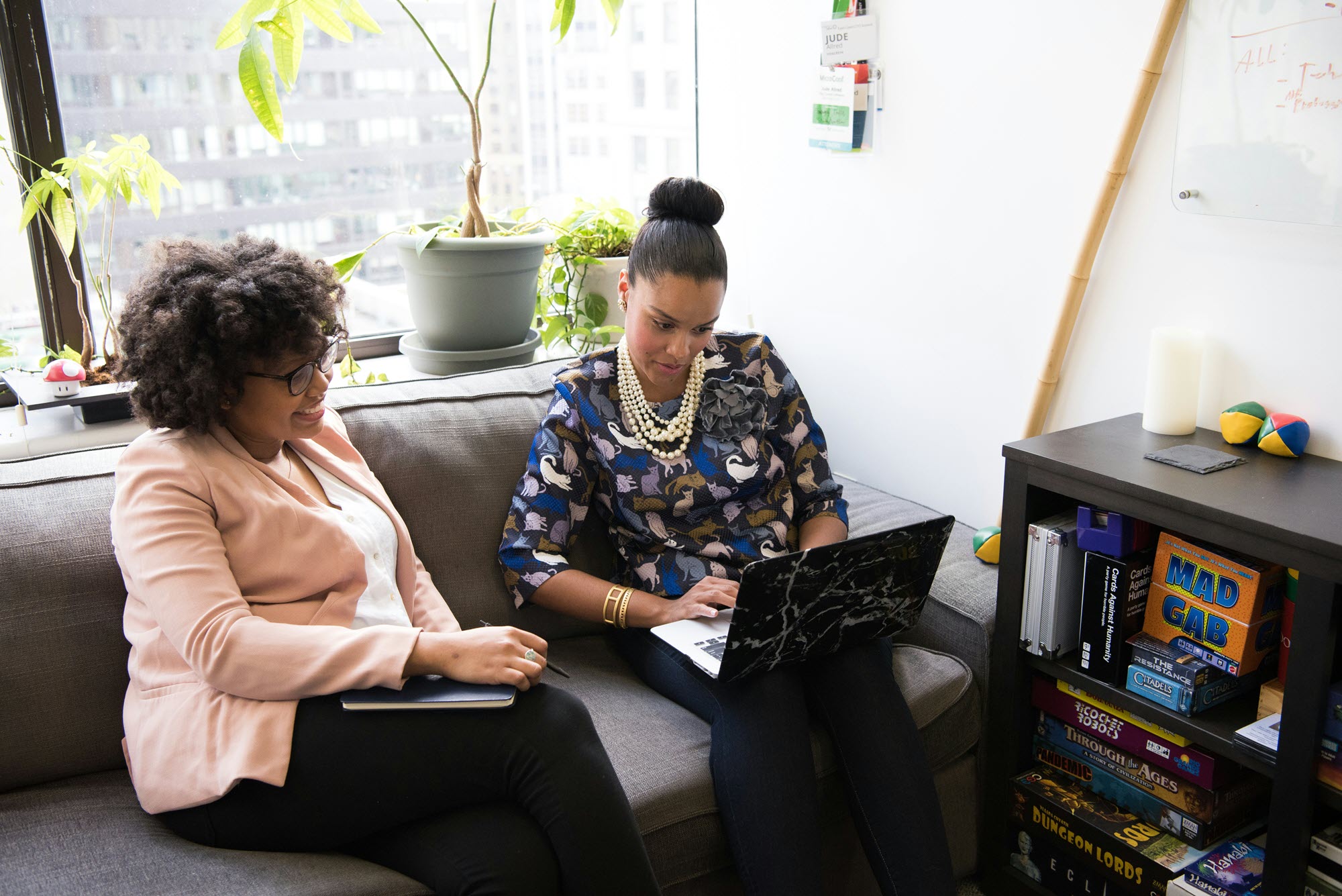 Photo of two women working together