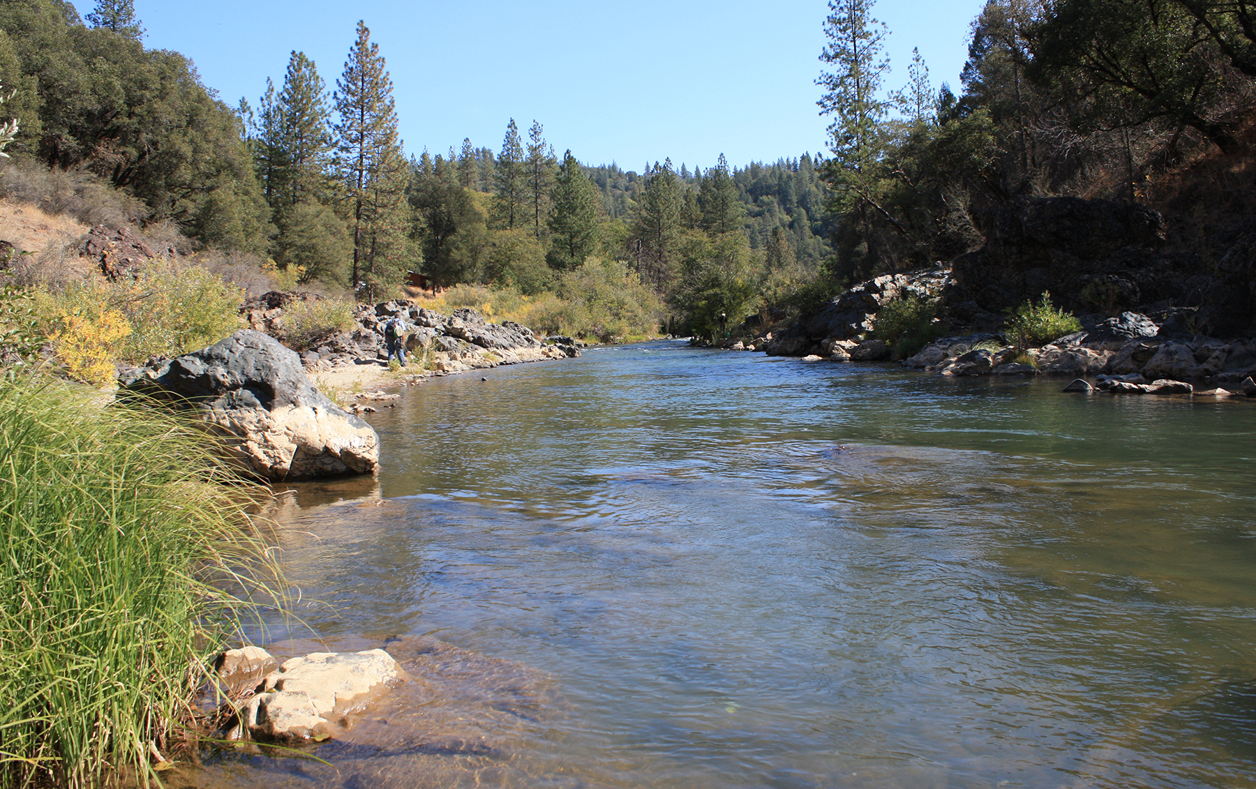 image of a river lined by rocks and trees image of a river lined by rocks and trees