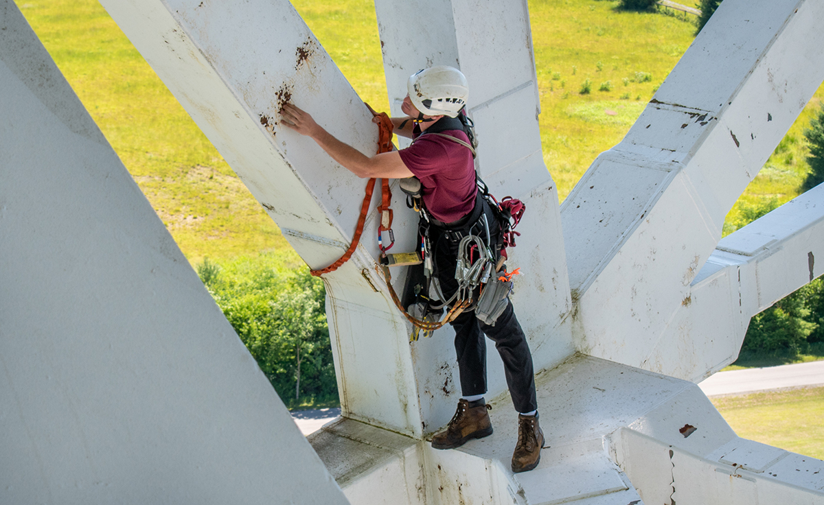 a person inspects the giant telescope a person inspects the giant telescope