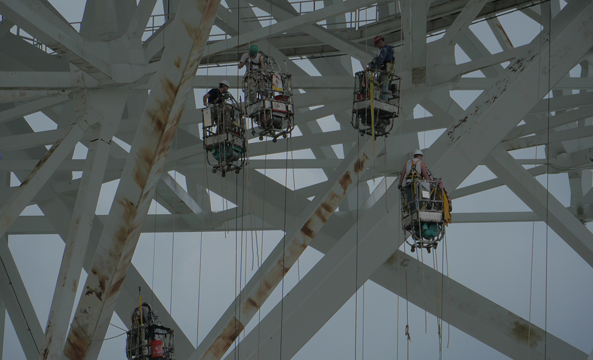 a crew performs painting on the giant telescope a crew performs painting on the giant telescope