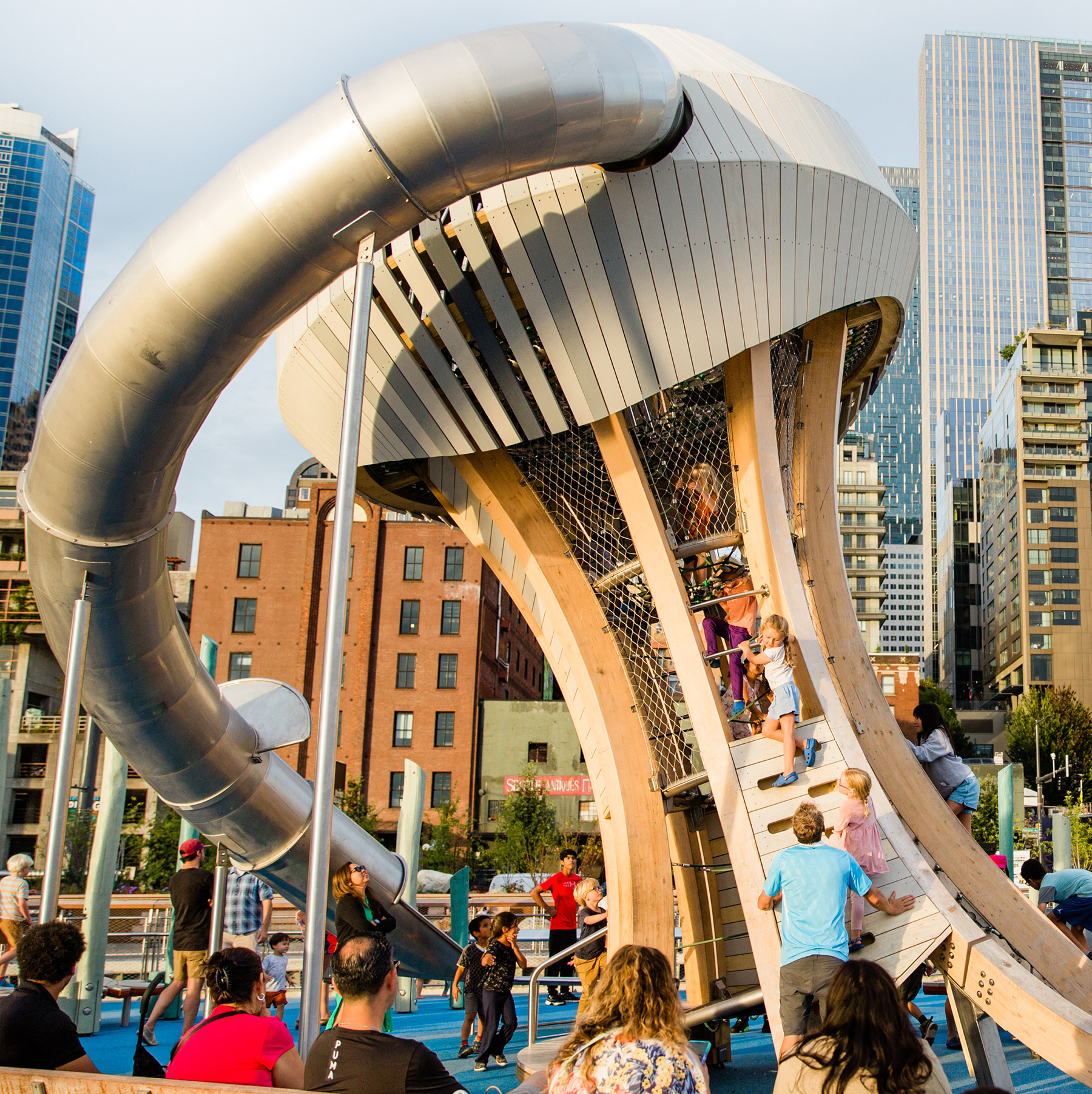 children play on an apparatus featuring a giant jellyfish-shaped structure