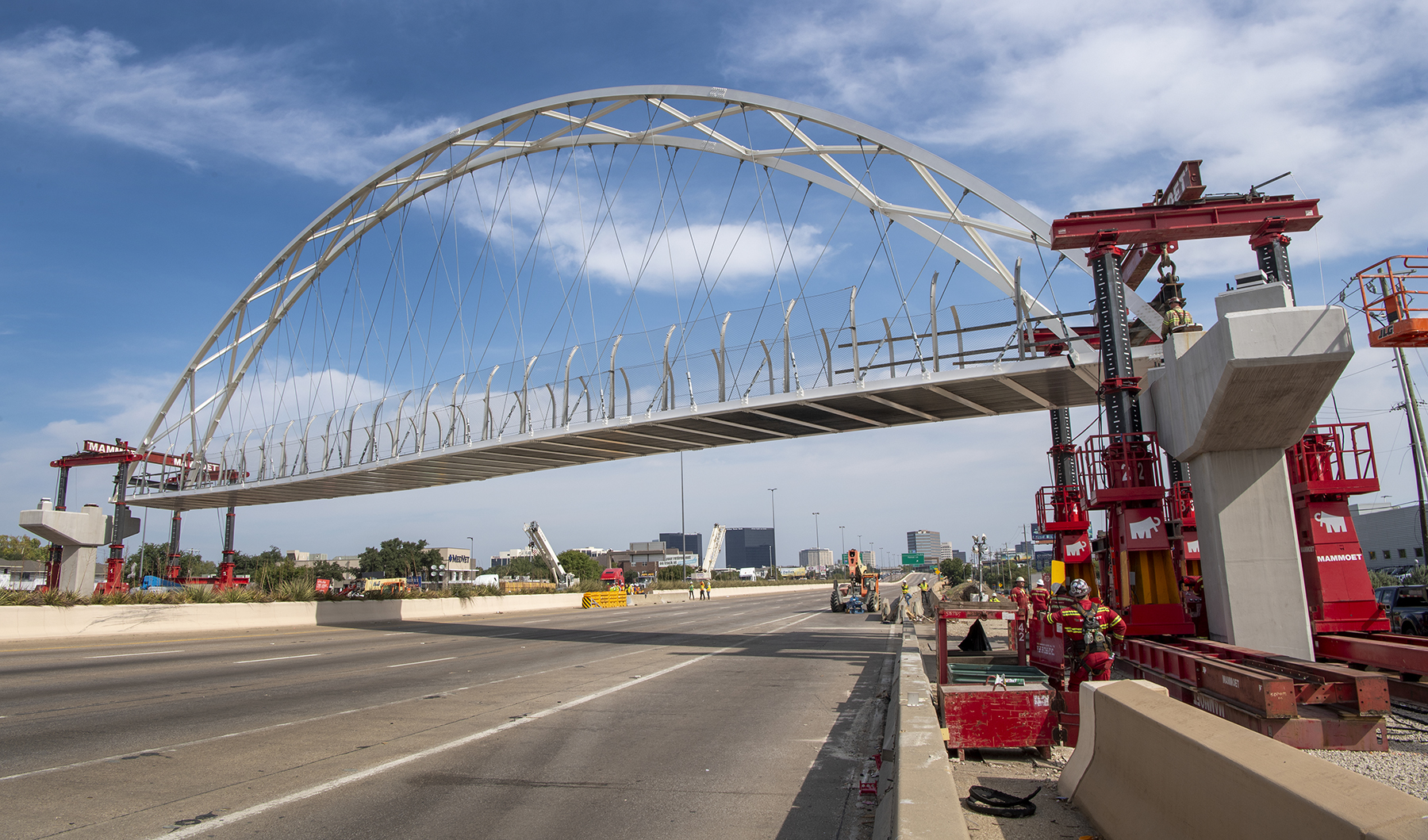 a pedestrian bridge spans a highway a pedestrian bridge spans a highway
