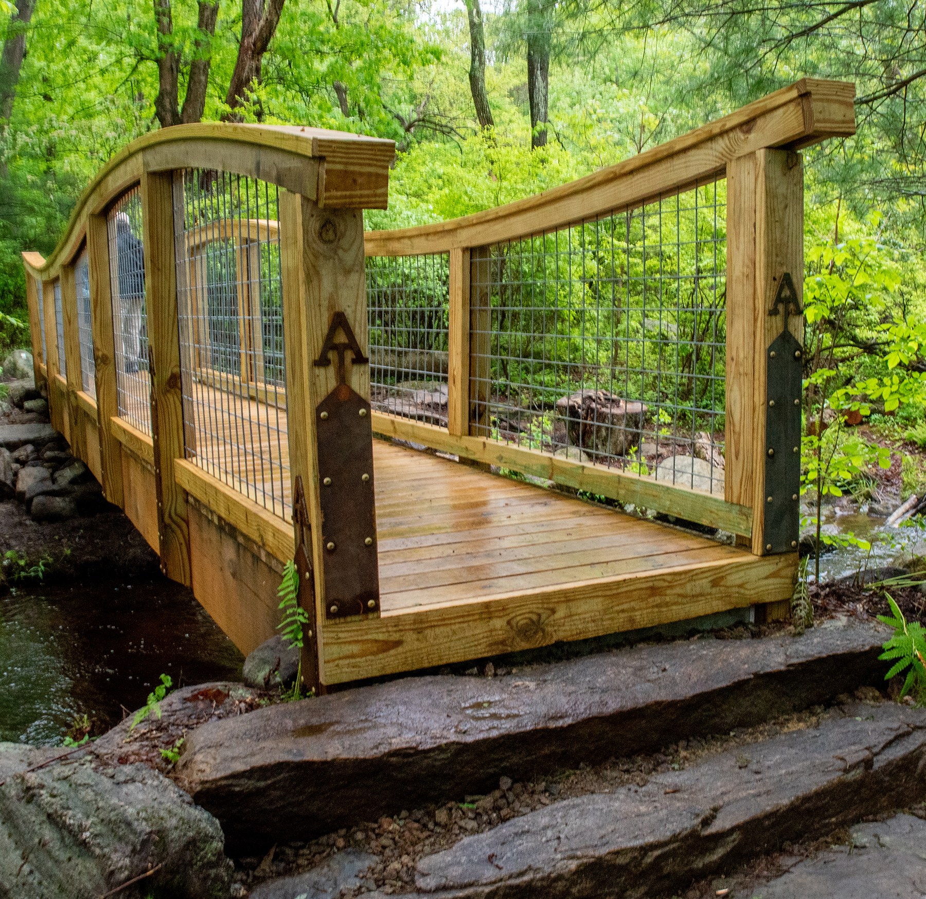 a wooden pedestrian bridge stretching across water