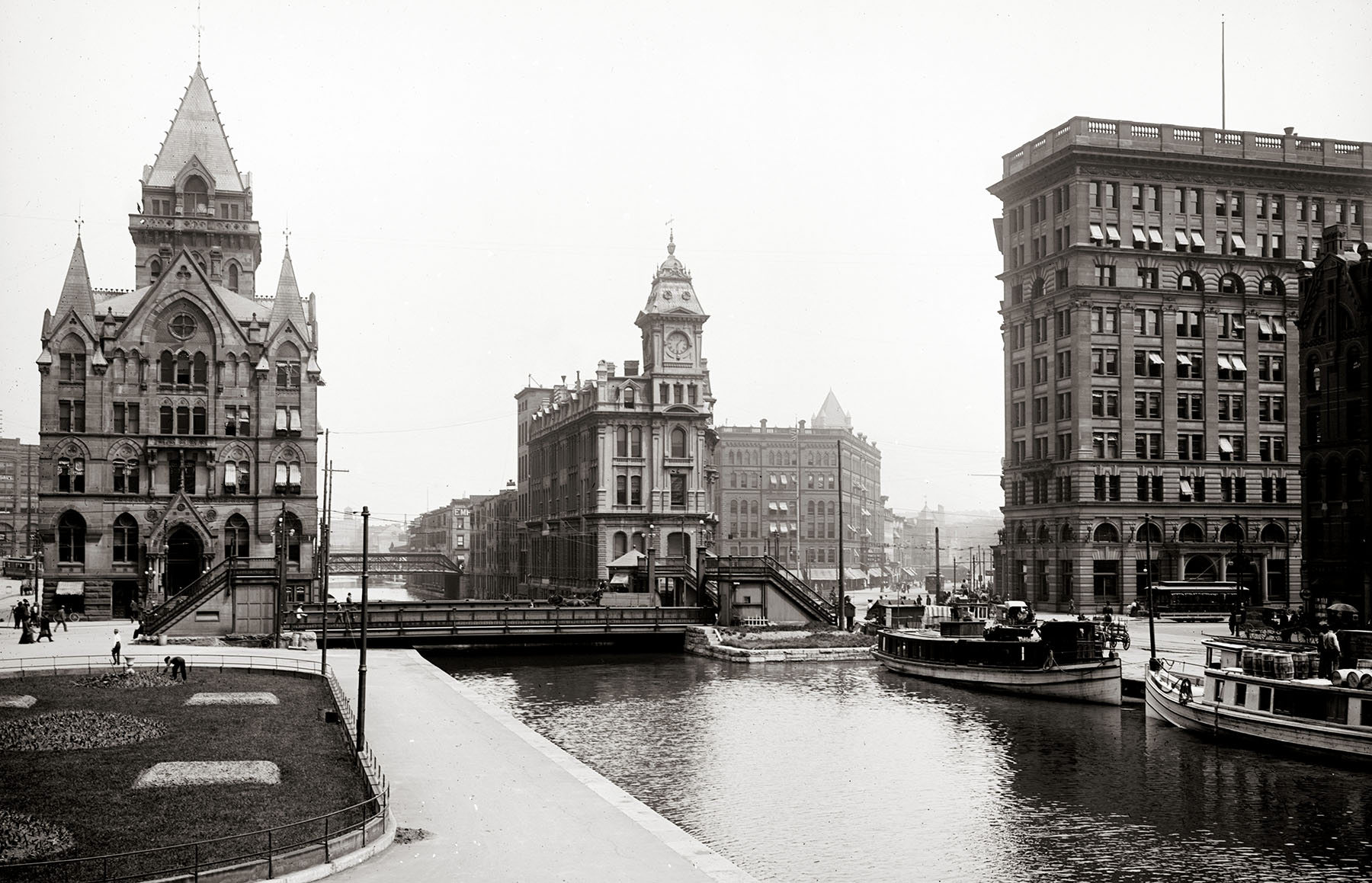 a black and white photo shows canal among tall buildings a black and white photo shows canal among tall buildings