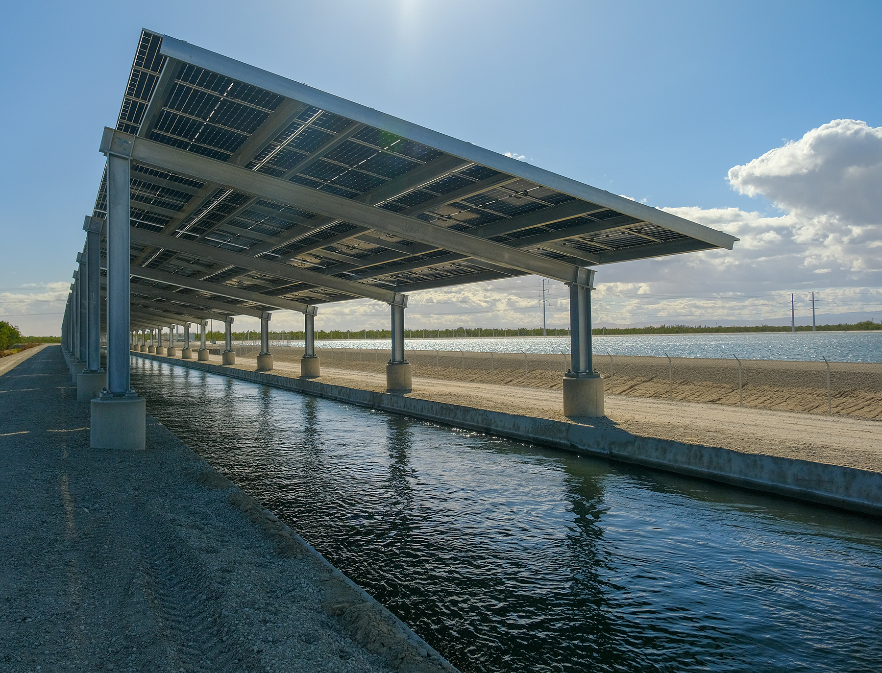 side view of solar panels over a canal