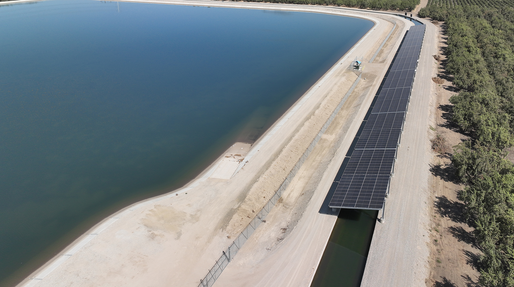 aerial view of solar panels over a canal