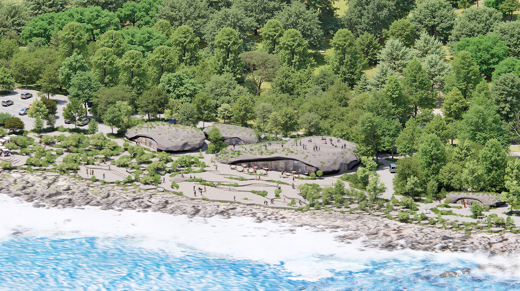 aerial view of structures built along a coast with trees in the background