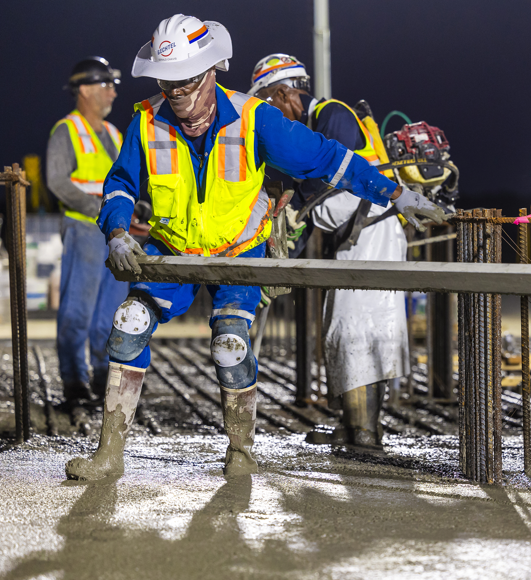 a crew works with wood beams and rebar