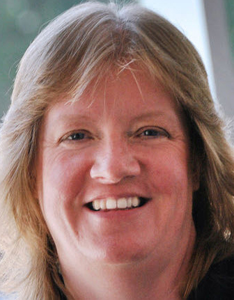 a woman smiles for the camera