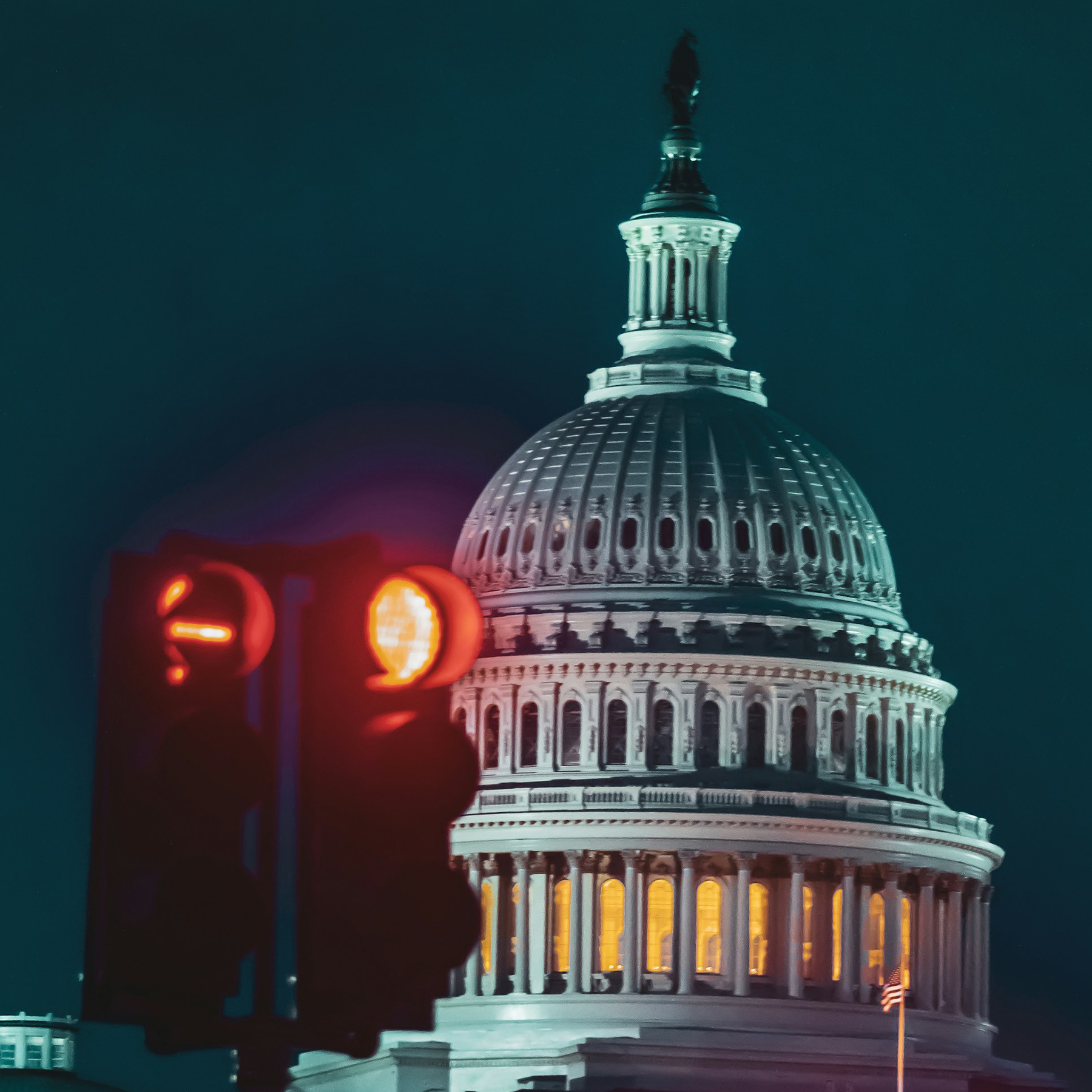 The domed U.S. Capitol building with traffic lights displaying red in the foreground