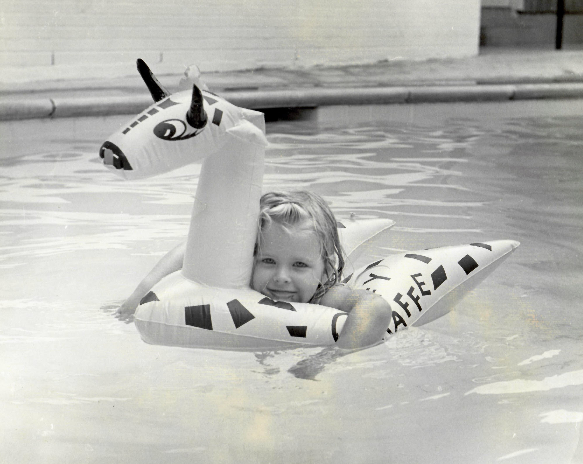 A young Carol Haddock swims in the pool