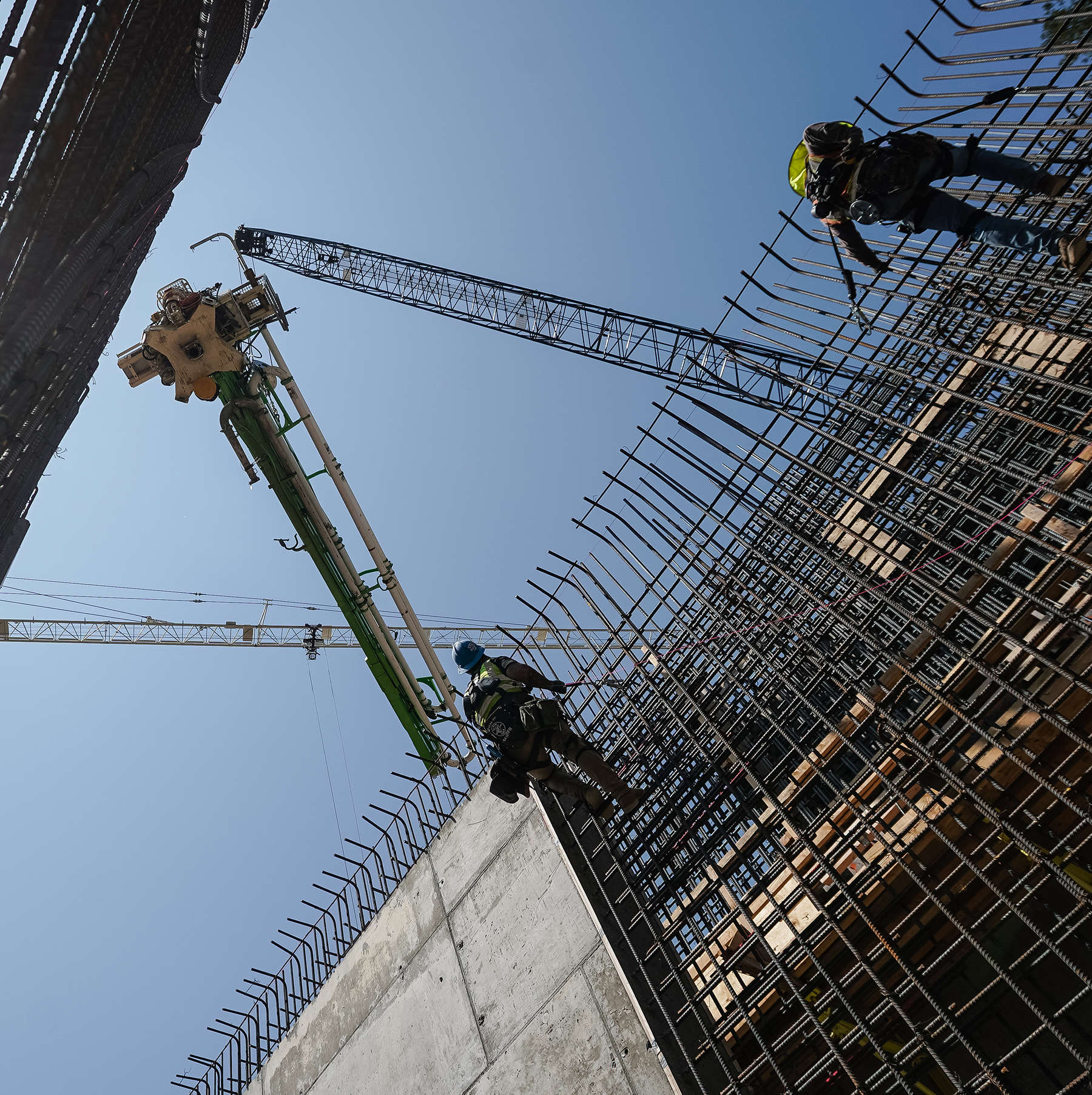 crews navigate secant pile walls of during underground excavation 