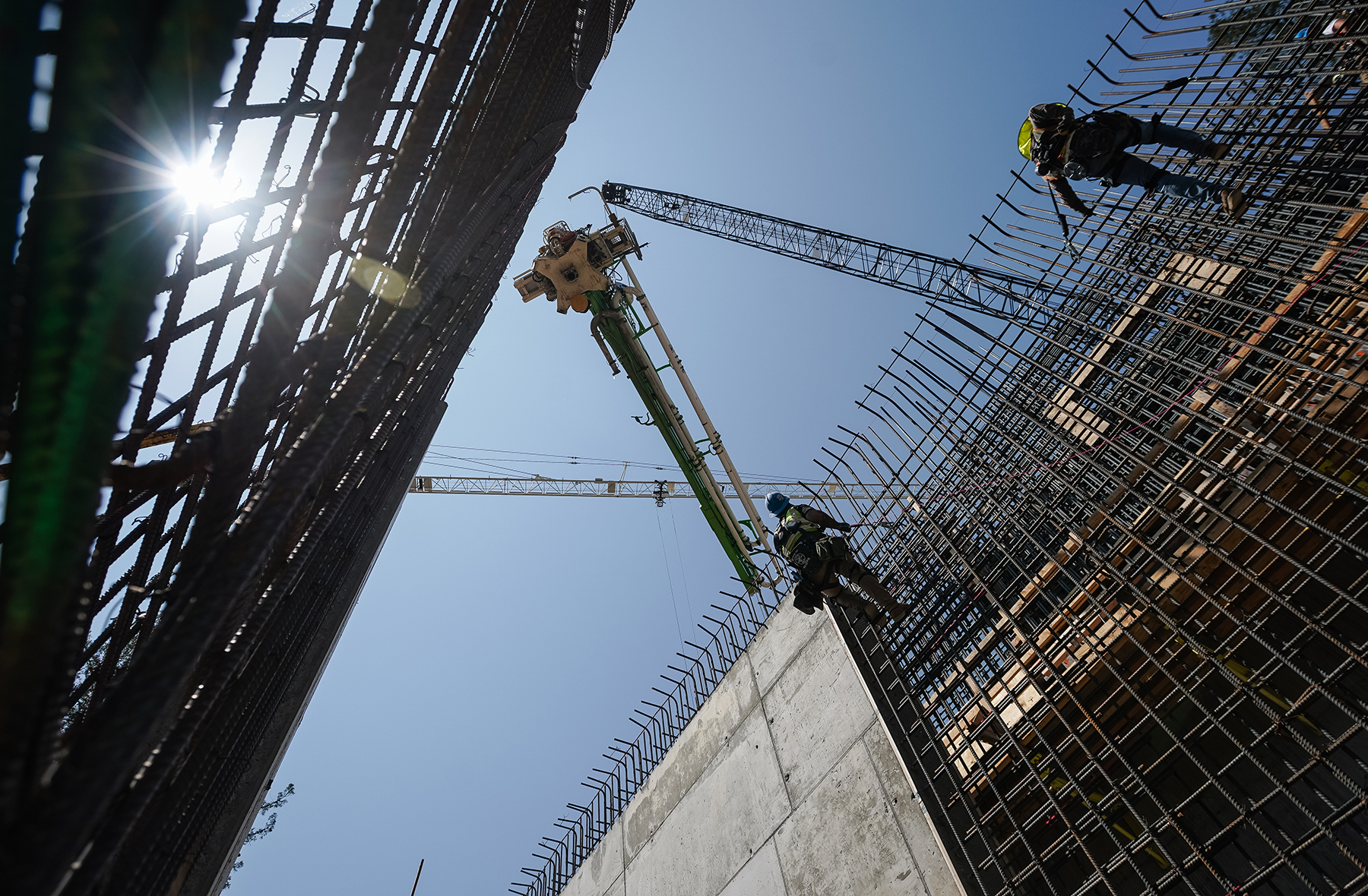 crews navigate secant pile walls of during underground excavation