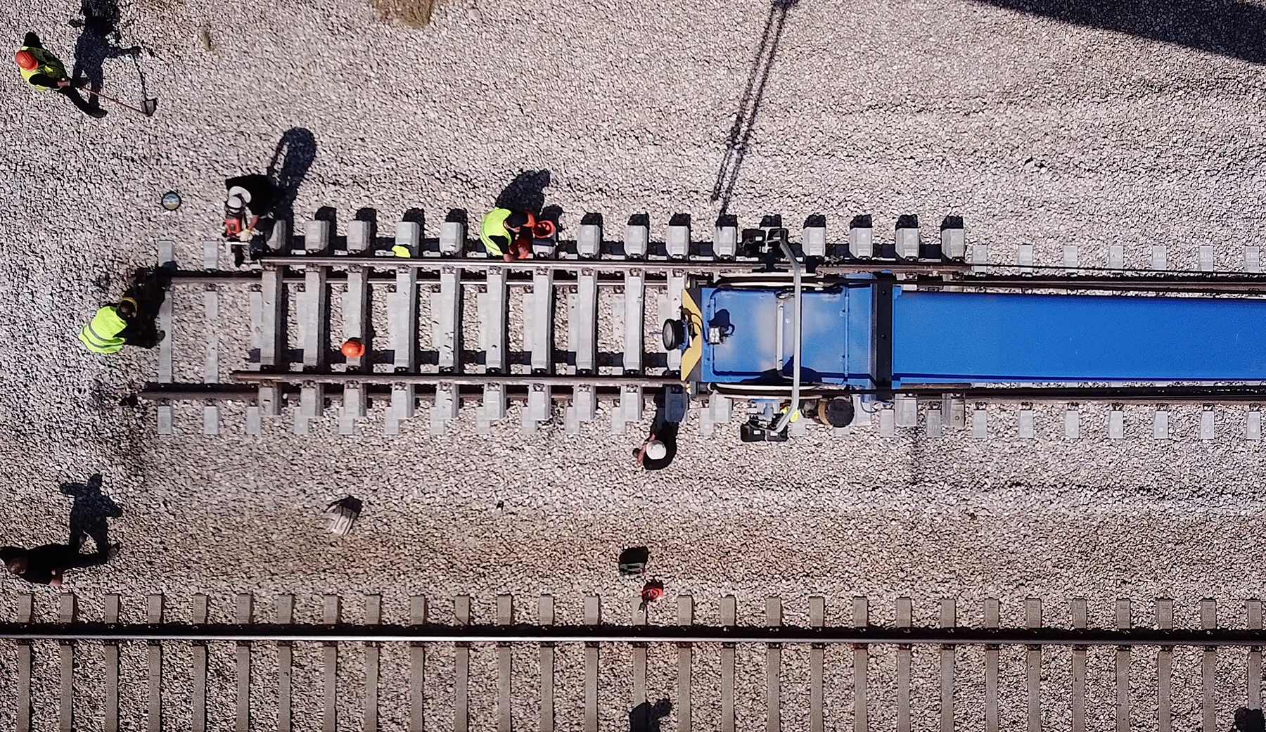 aerial view of people working on a railroad track