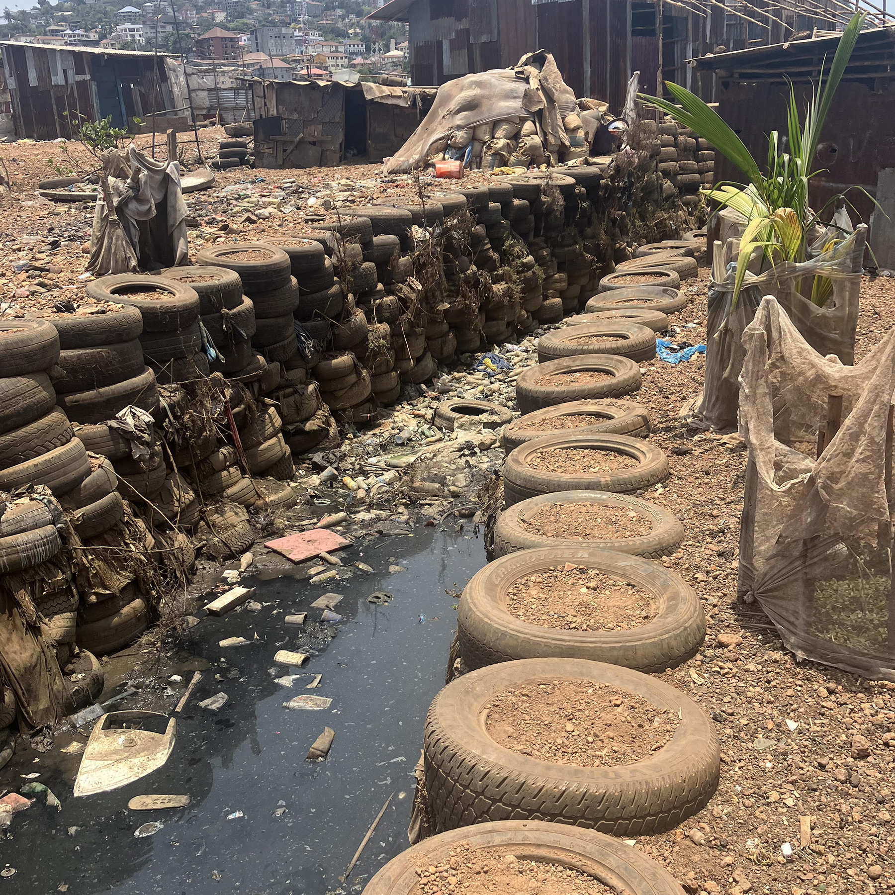 old, infilled tires line a channel