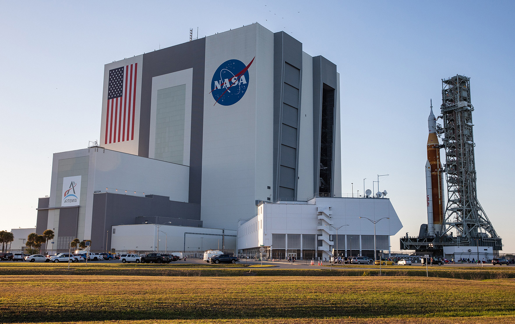 a rocket is transported away from the vehicle assembly building at Kennedy Space Center