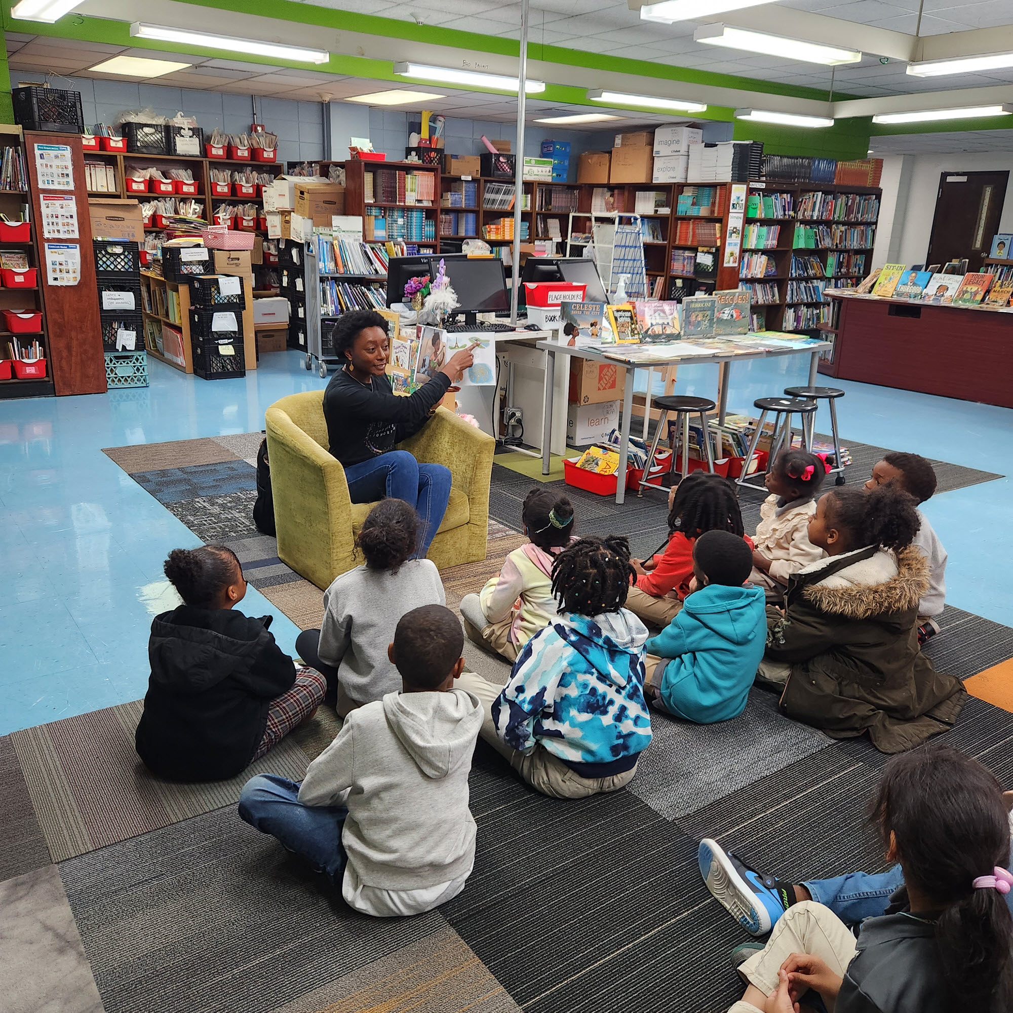 Photo of Courtney Kelly reading to children