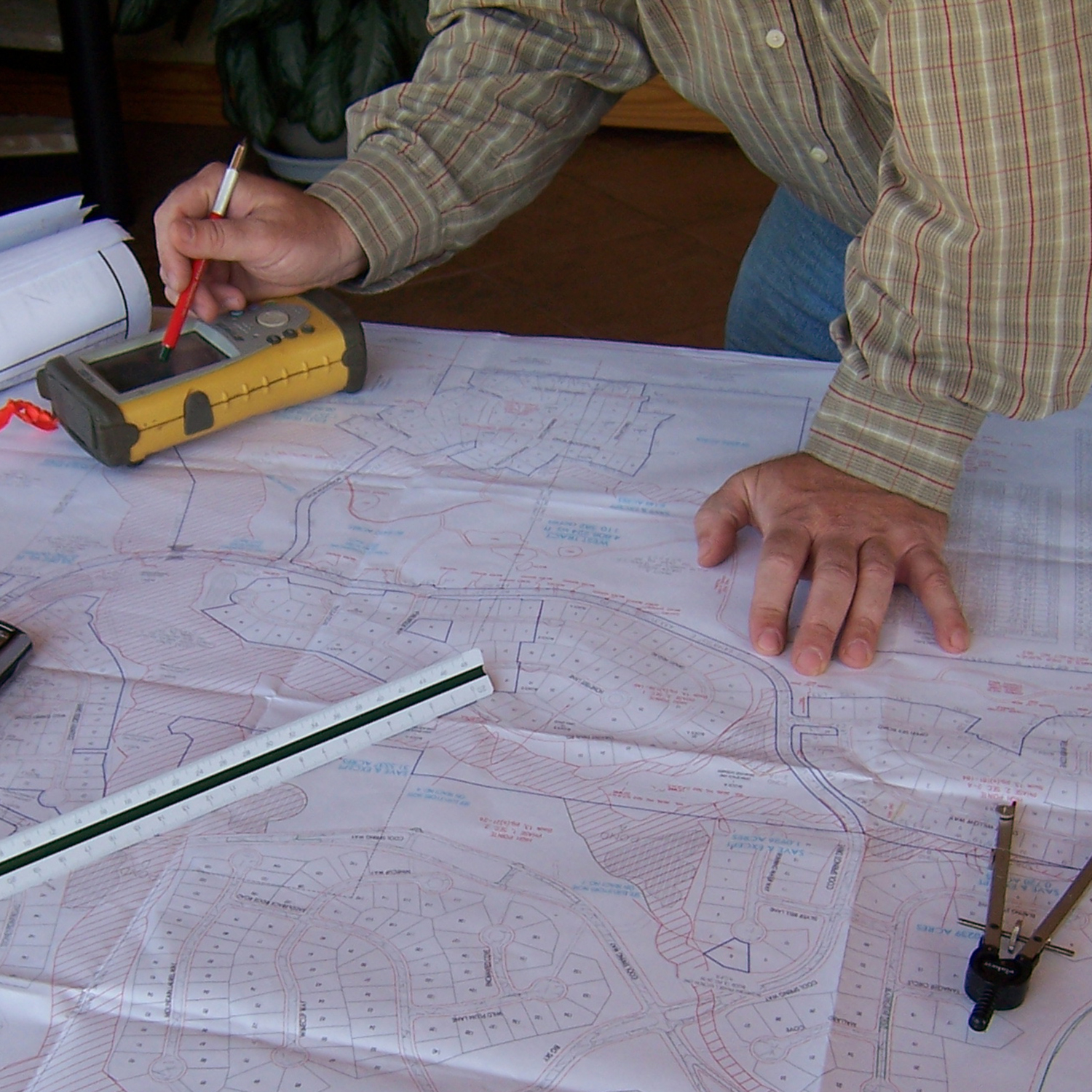 a civil engineer works with the tools of the trade on a table