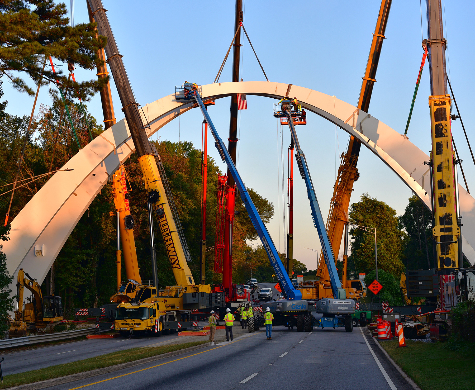 cranes lift steel arches into place