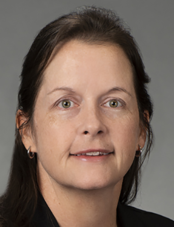 a woman smiles for the camera