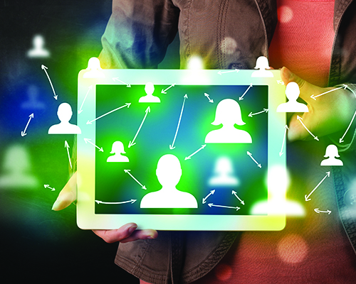 Representing crowdsourcing, a digital tablet being held with icons of interconnected people