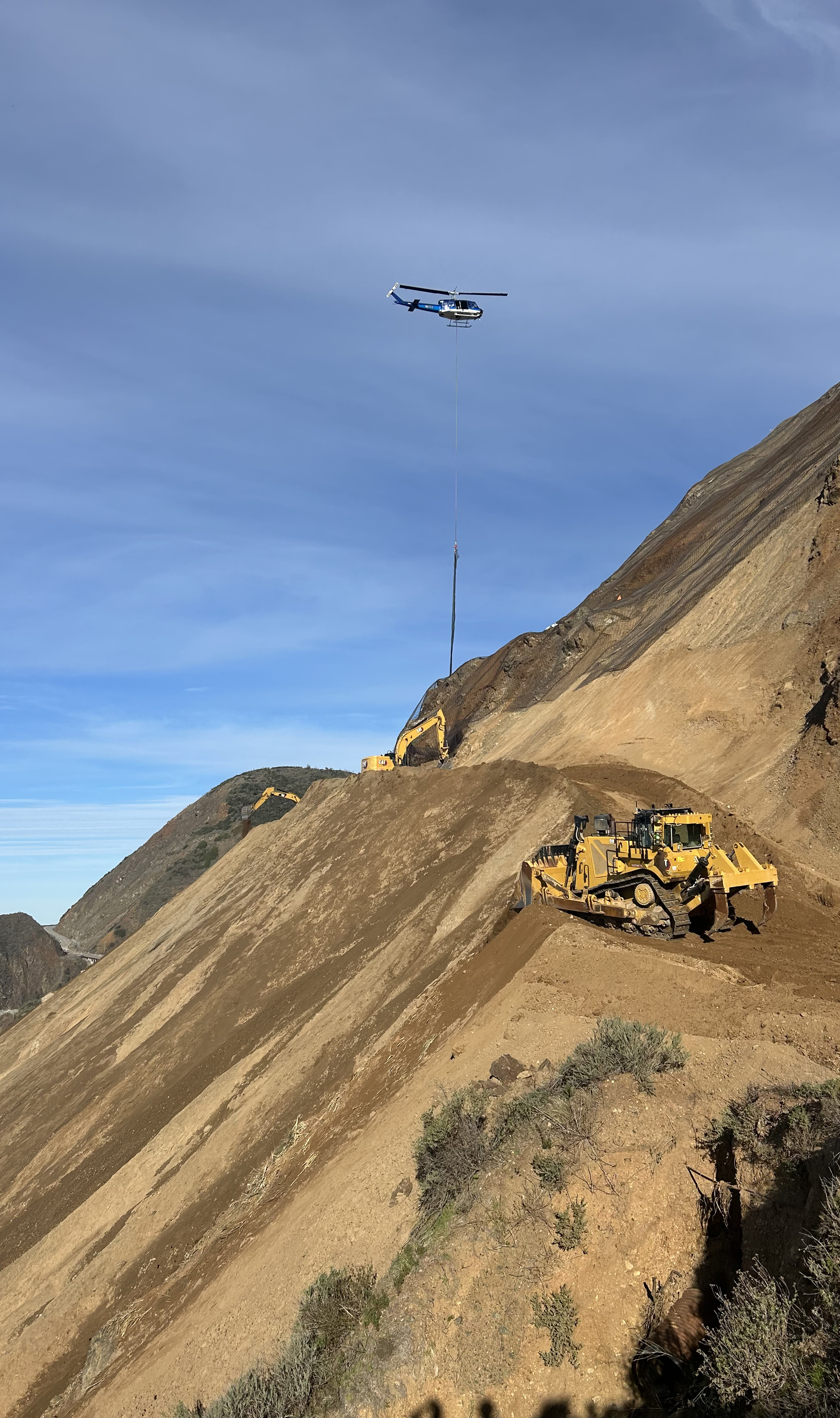 Helicopter assisting with slope work