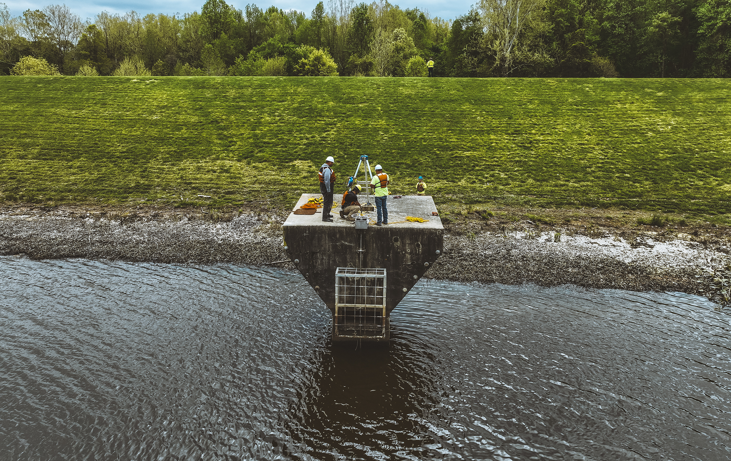 workers inspect a dam riser