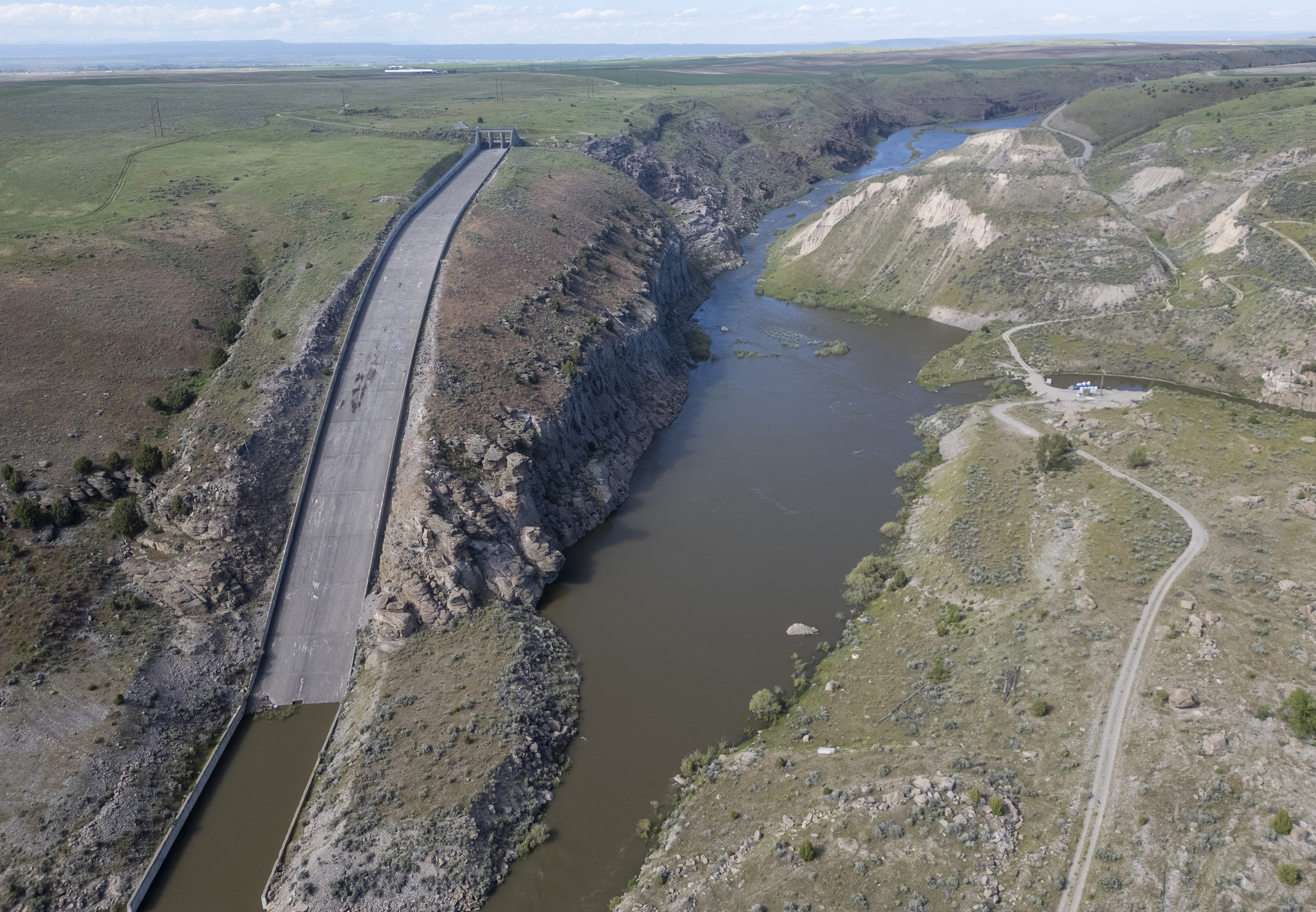 old dam remnants beside a winding river