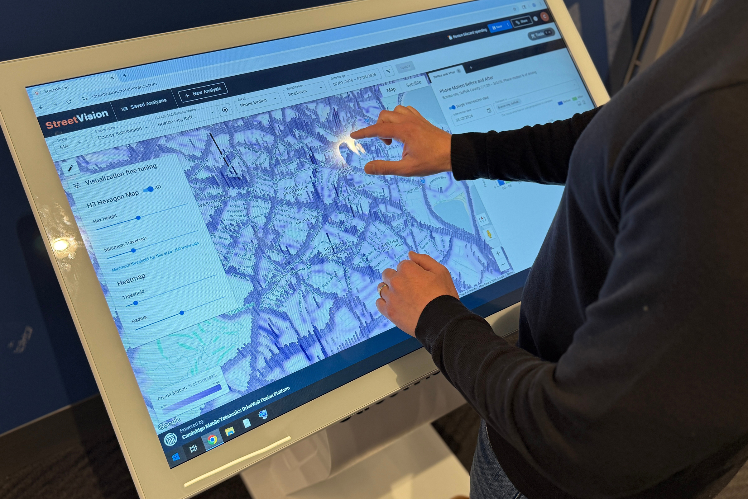 a person works on a touchscreen displaying a map