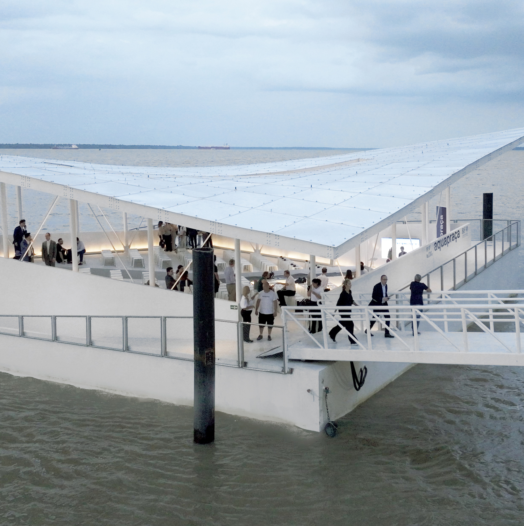 people gather on a floating structure